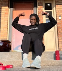 a woman sitting on the steps of a house